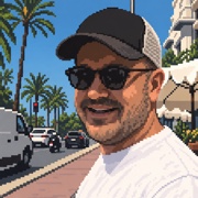 Utku Aytaç, in a pixel-art portrait: a cap and sunglasses, with palm trees and a sunlit street behind him.